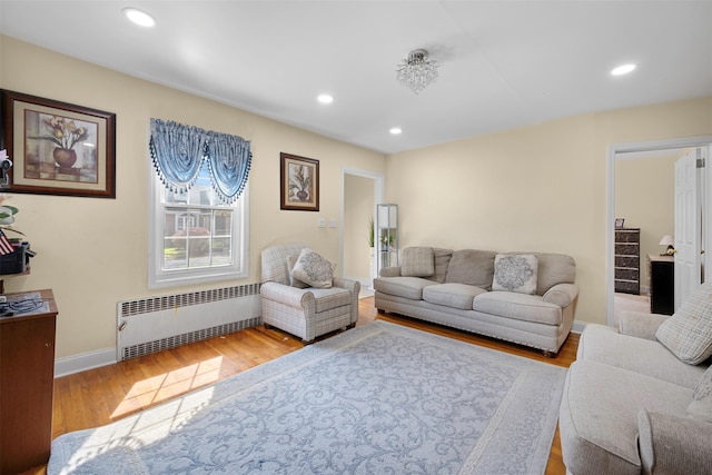 31 Pilgrim St, New Hyde Park, NY 11040 - living room featuring radiator, wood finished floors, and recessed lighting