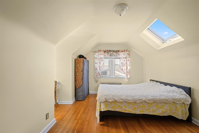 31 Pilgrim St, New Hyde Park, NY 11040 - bedroom with a skylight, vaulted ceiling, wood finished floors, and radiator