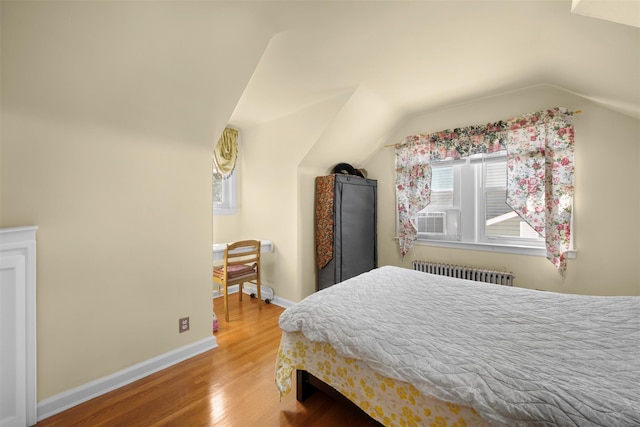 31 Pilgrim St, New Hyde Park, NY 11040 - bedroom with radiator heating unit, lofted ceiling, and wood finished floors