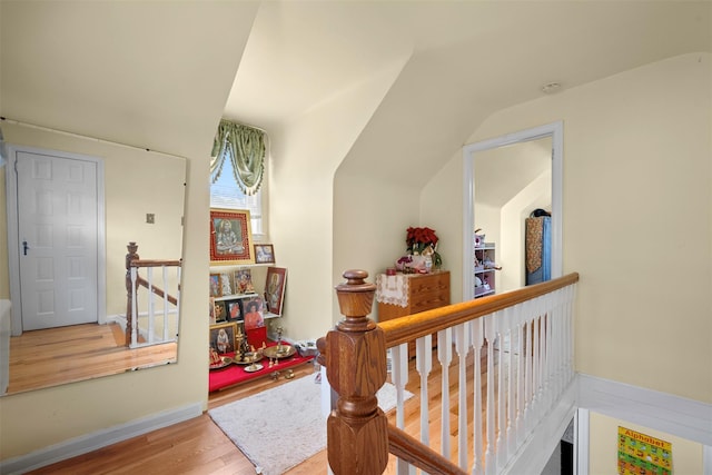31 Pilgrim St, New Hyde Park, NY 11040 - hallway featuring wood finished floors, lofted ceiling, and an upstairs landing