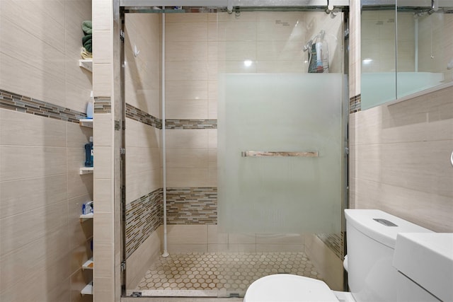 31 Pilgrim St, New Hyde Park, NY 11040 - bathroom featuring tile walls, a stall shower, and tile patterned floors
