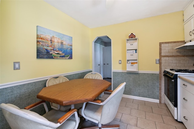 6 Vermont St, Lindenhurst, NY 11757 - dining room with wainscoting, arched walkways, and light tile patterned flooring