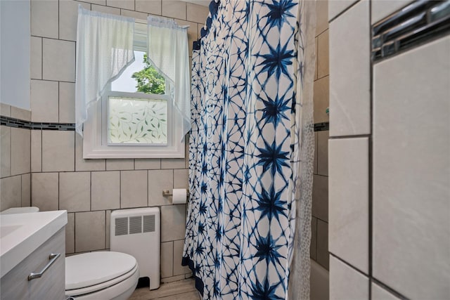 6 Vermont St, Lindenhurst, NY 11757 - bathroom with radiator heating unit, tile walls, vanity, and shower / bathtub combination with curtain