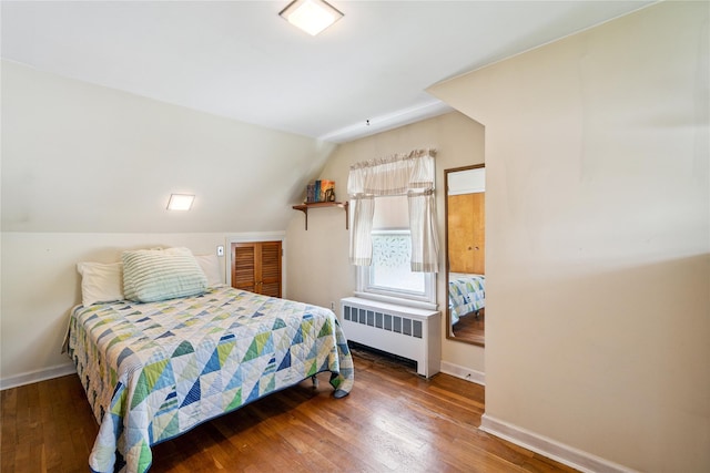 6 Vermont St, Lindenhurst, NY 11757 - bedroom with radiator, wood finished floors, and lofted ceiling