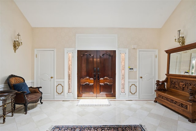 10 Laurel Woods Dr, Upper Brookville, NY 11771 - entryway featuring vaulted ceiling, a decorative wall, and a wainscoted wall