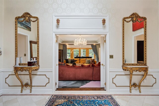 10 Laurel Woods Dr, Upper Brookville, NY 11771 - foyer with ornamental molding, light tile patterned floors, a chandelier, inlaid floor details, and wallpapered walls