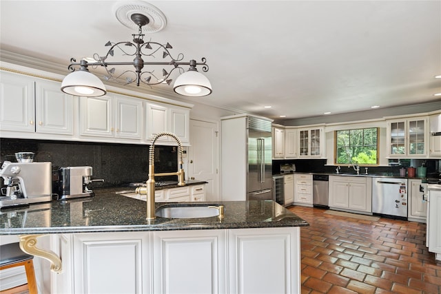 10 Laurel Woods Dr, Upper Brookville, NY 11771 - kitchen with stainless steel appliances, a peninsula, decorative backsplash, glass insert cabinets, and ornamental molding