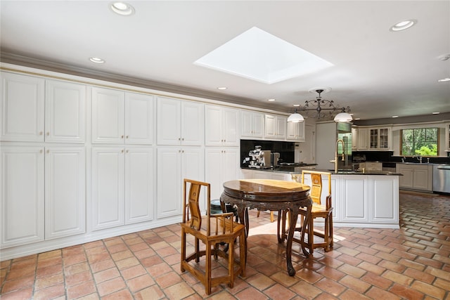 10 Laurel Woods Dr, Upper Brookville, NY 11771 - dining room featuring brick floors, a skylight, recessed lighting, a chandelier, and crown molding