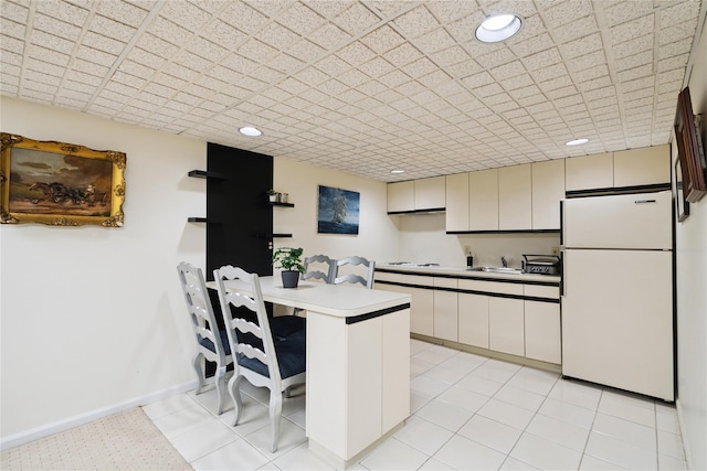 10 Laurel Woods Dr, Upper Brookville, NY 11771 - kitchen with freestanding refrigerator, a peninsula, light countertops, a breakfast bar, and recessed lighting
