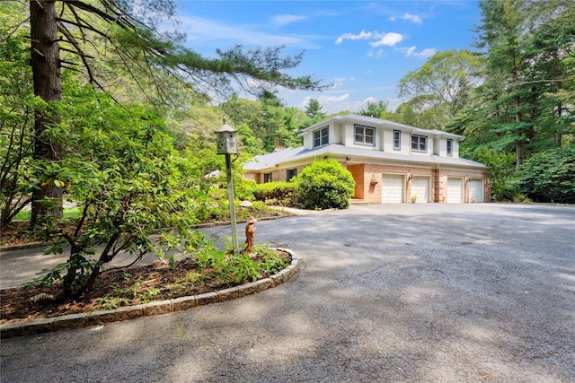 10 Laurel Woods Dr, Upper Brookville, NY 11771 - view of front facade featuring asphalt driveway and a garage