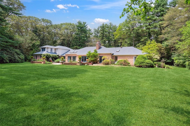 10 Laurel Woods Dr, Upper Brookville, NY 11771 - back of property featuring a chimney and a yard