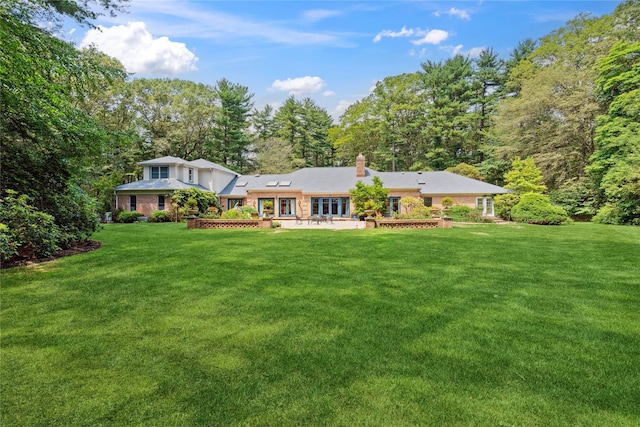 10 Laurel Woods Dr, Upper Brookville, NY 11771 - back of house featuring a lawn and a chimney