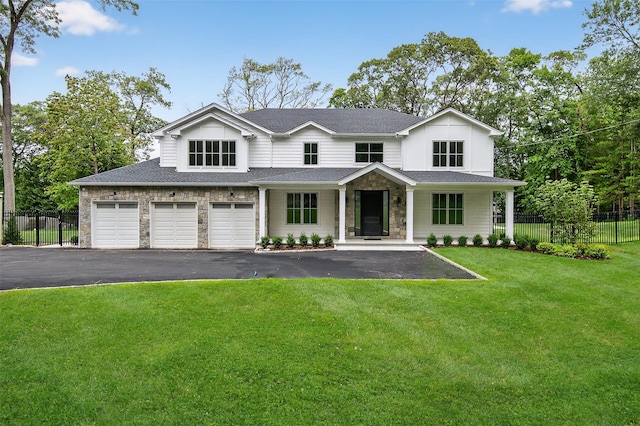 32A Pine Rd, Syosset, NY 11791 - view of front of home with asphalt driveway, a garage, stone siding, roof with shingles, and covered porch