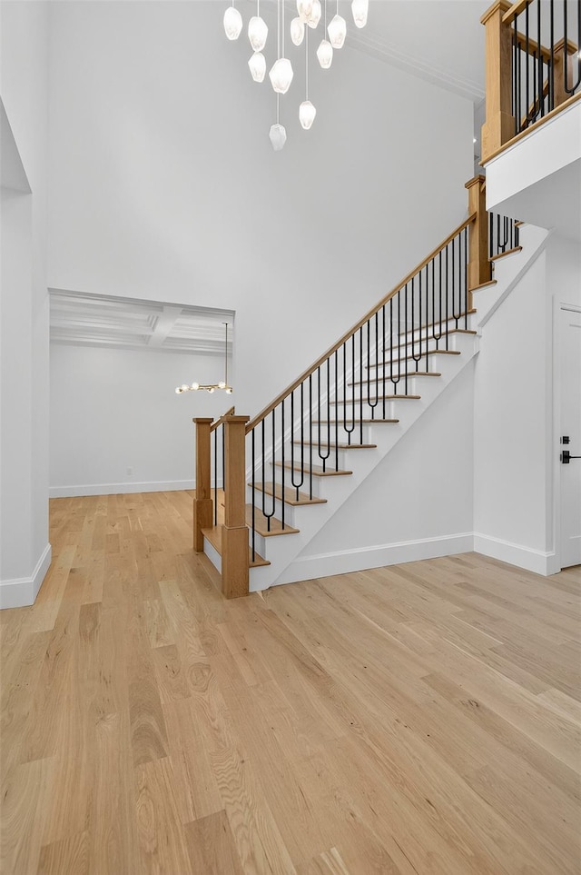 32A Pine Rd, Syosset, NY 11791 - staircase featuring wood finished floors and a chandelier