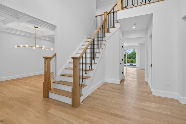 32A Pine Rd, Syosset, NY 11791 - stairway featuring wood finished floors, a chandelier, coffered ceiling, beamed ceiling, and ornamental molding