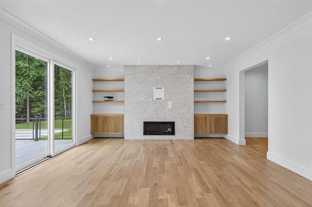 32A Pine Rd, Syosset, NY 11791 - unfurnished living room featuring crown molding, light wood-type flooring, and a large fireplace