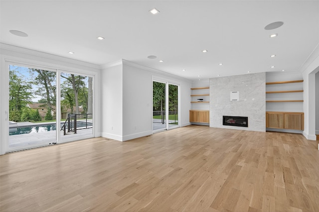 32A Pine Rd, Syosset, NY 11791 - unfurnished living room with ornamental molding, light wood-type flooring, healthy amount of natural light, a fireplace, and recessed lighting