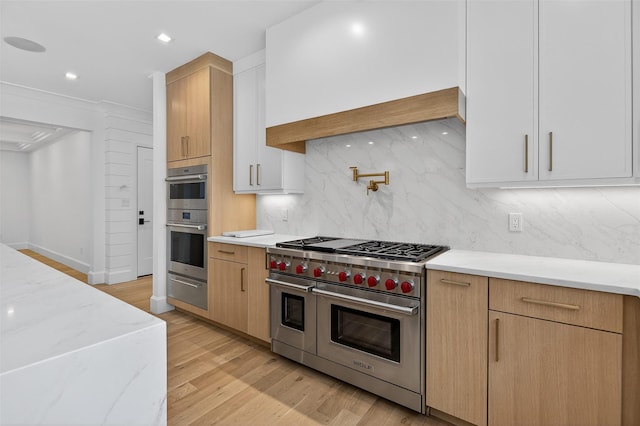 32A Pine Rd, Syosset, NY 11791 - kitchen featuring stainless steel appliances, light stone counters, tasteful backsplash, a warming drawer, and light wood finished floors