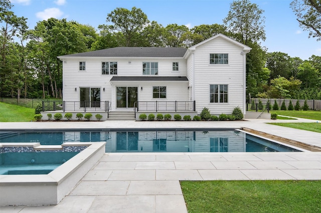 32A Pine Rd, Syosset, NY 11791 - back of property with a patio, a pool with connected hot tub, and view of scattered trees