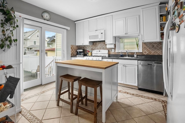 51 Lincoln St, New Rochelle, NY 10801 - kitchen with white appliances, butcher block countertops, light tile patterned floors, and inlaid floor details