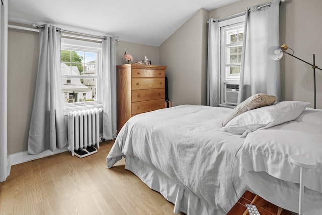 51 Lincoln St, New Rochelle, NY 10801 - bedroom with radiator, light wood-style floors, lofted ceiling, and cooling unit