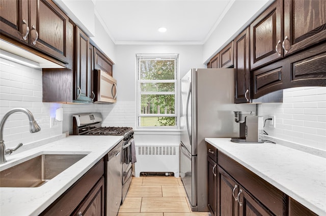 10 Bryant Cres Unit 1J, White Plains, NY 10605 - kitchen featuring stainless steel appliances, backsplash, radiator heating unit, ornamental molding, and light stone countertops