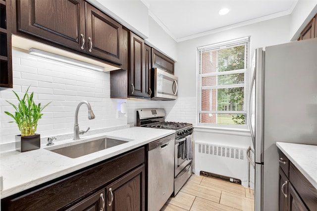 10 Bryant Cres Unit 1J, White Plains, NY 10605 - kitchen with appliances with stainless steel finishes, radiator, dark brown cabinets, crown molding, and backsplash