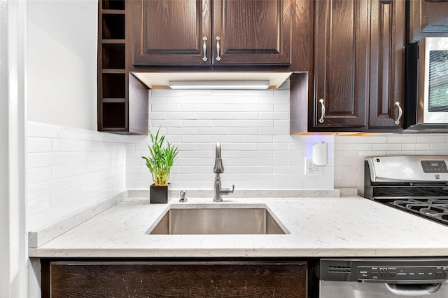 10 Bryant Cres Unit 1J, White Plains, NY 10605 - kitchen featuring dark brown cabinetry, stainless steel appliances, tasteful backsplash, and light stone counters