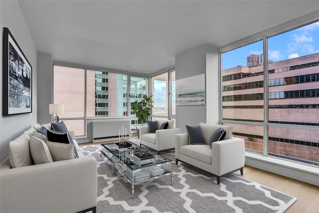 635 W 42nd St Unit 7A, New York Manhattan, NY 10036 - living room featuring wood finished floors, plenty of natural light, and expansive windows