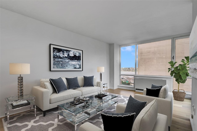 635 W 42nd St Unit 7A, New York Manhattan, NY 10036 - living room featuring wood finished floors and baseboards