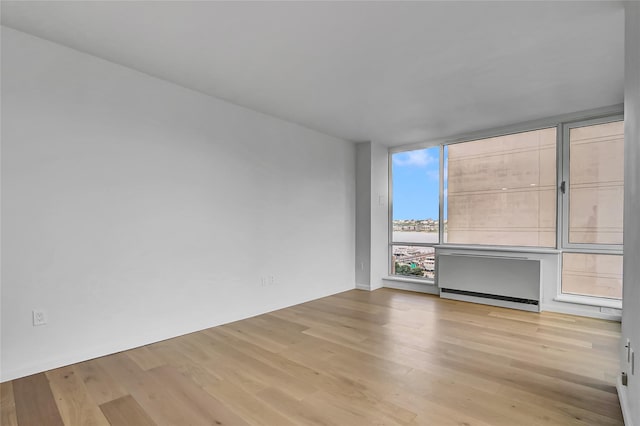 635 W 42nd St Unit 7A, New York Manhattan, NY 10036 - spare room featuring wood finished floors