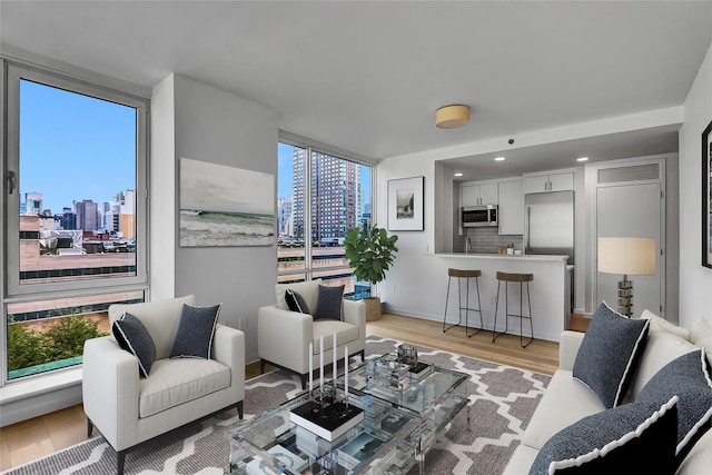 635 W 42nd St Unit 7A, New York Manhattan, NY 10036 - living area with a skyline view and light wood-type flooring