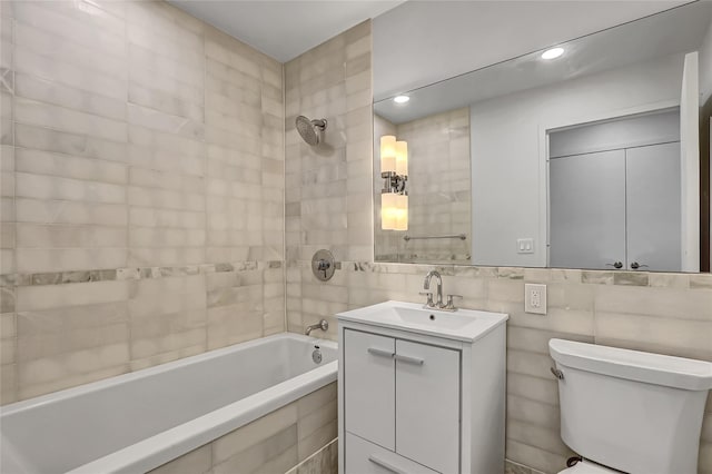 635 W 42nd St Unit 7A, New York Manhattan, NY 10036 - bathroom with vanity, tiled shower / bath, tile walls, and recessed lighting