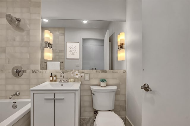 635 W 42nd St Unit 7A, New York Manhattan, NY 10036 - full bathroom featuring tile walls, vanity, recessed lighting, and bathing tub / shower combination