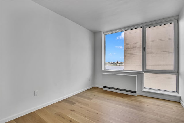 635 W 42nd St Unit 7A, New York Manhattan, NY 10036 - unfurnished room featuring baseboards and light wood-type flooring