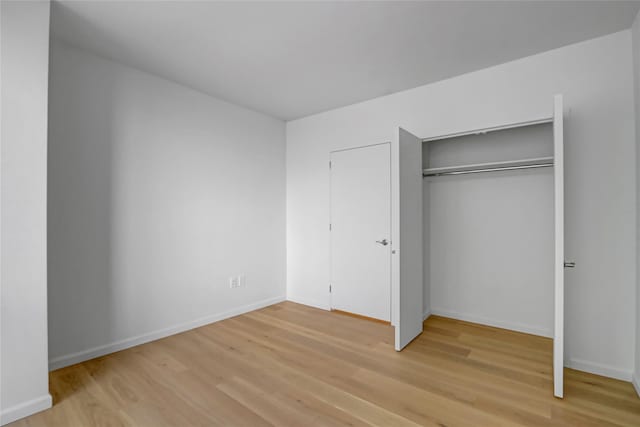 635 W 42nd St Unit 7A, New York Manhattan, NY 10036 - unfurnished bedroom with light wood-style floors and a closet