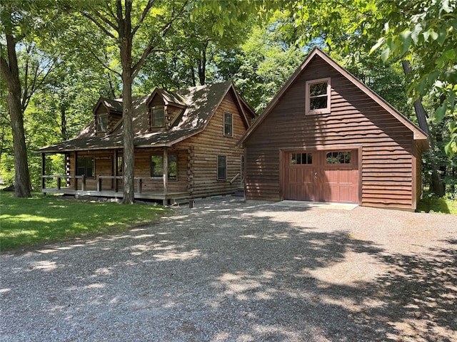 5 Will Palmer Rd, Catskill, NY 12414 - view of front of house featuring a detached garage, covered porch, driveway, log exterior, and an outbuilding