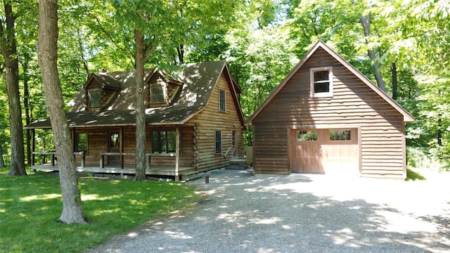 5 Will Palmer Rd, Catskill, NY 12414 - view of front facade with covered porch, a detached garage, an outbuilding, asphalt driveway, and a front lawn