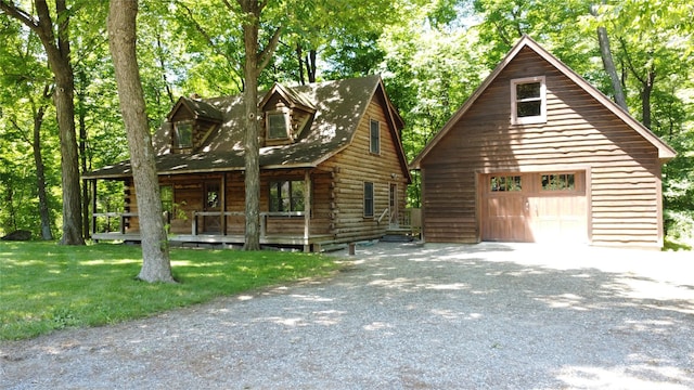 5 Will Palmer Rd, Catskill, NY 12414 - view of front of house with a garage, a porch, an outbuilding, log exterior, and driveway