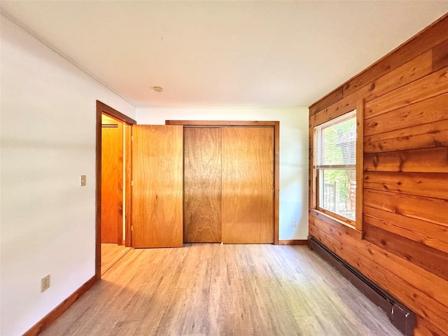 5 Will Palmer Rd, Catskill, NY 12414 - unfurnished bedroom featuring a baseboard heating unit, wood finished floors, and a closet