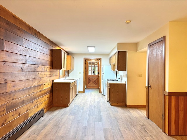 5 Will Palmer Rd, Catskill, NY 12414 - kitchen featuring a baseboard radiator, wooden walls, light countertops, white stove, and light wood-style flooring