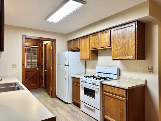 5 Will Palmer Rd, Catskill, NY 12414 - kitchen featuring white appliances, light wood-style flooring, light countertops, and brown cabinetry