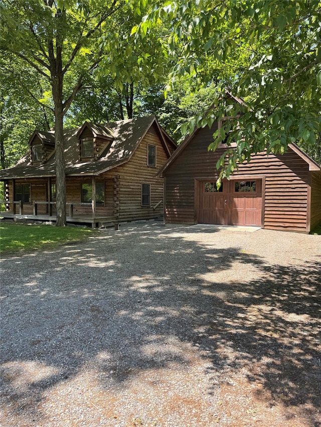 5 Will Palmer Rd, Catskill, NY 12414 - view of front of home featuring an outbuilding, a garage, log exterior, and gravel driveway