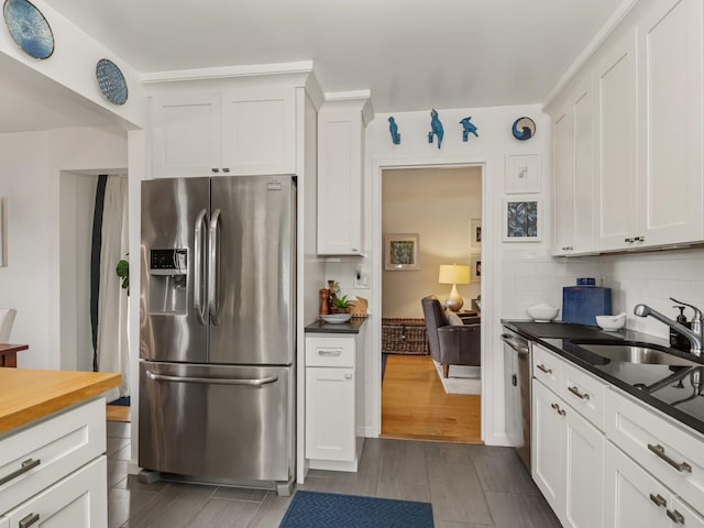 666 Pelham Rd Unit 3N, New Rochelle, NY 10805 - kitchen featuring stainless steel refrigerator with ice dispenser, decorative backsplash, and white cabinets