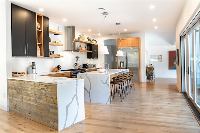 11 Lawrence Ln, Palisades, NY 10964 - kitchen featuring stainless steel appliances, island exhaust hood, open shelves, light wood-type flooring, and decorative light fixtures