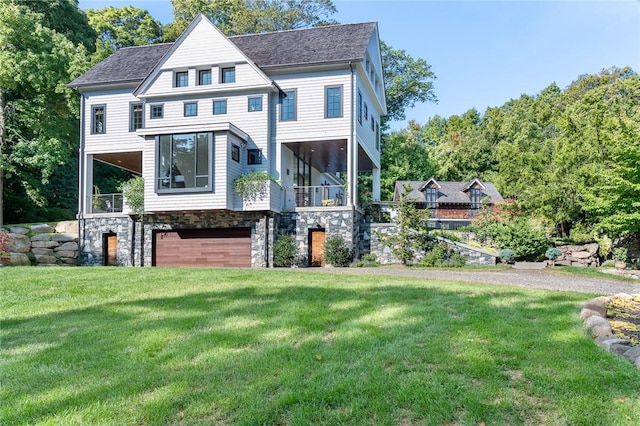 11 Lawrence Ln, Palisades, NY 10964 - view of front of house featuring stone siding, a front lawn, a garage, a balcony, and a shingled roof