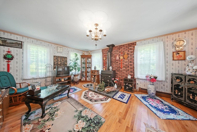TR34 10 Hoffman Rd, Fremont Center, NY 12736 - living area featuring wallpapered walls, a wood stove, wood finished floors, a chandelier, and ornamental molding