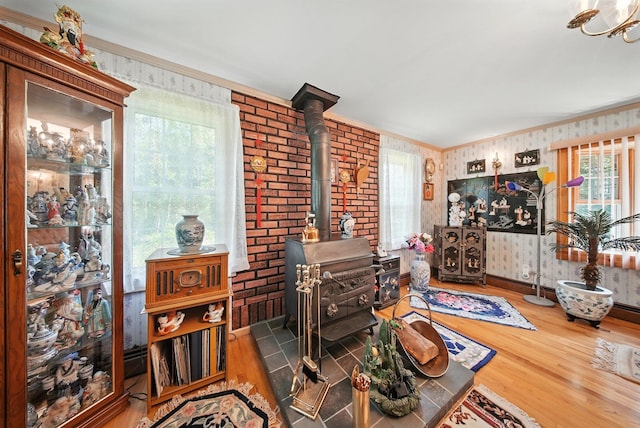 TR34 10 Hoffman Rd, Fremont Center, NY 12736 - living area with a wood stove, ornamental molding, wallpapered walls, and wood finished floors