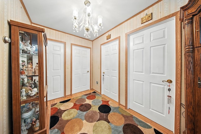 TR34 10 Hoffman Rd, Fremont Center, NY 12736 - foyer with ornamental molding, a chandelier, light wood-style flooring, and wallpapered walls