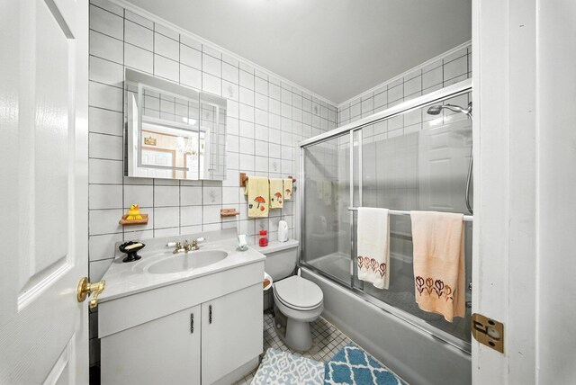 TR34 10 Hoffman Rd, Fremont Center, NY 12736 - bathroom with tile walls, vanity, shower / bath combination with glass door, tile patterned flooring, and crown molding